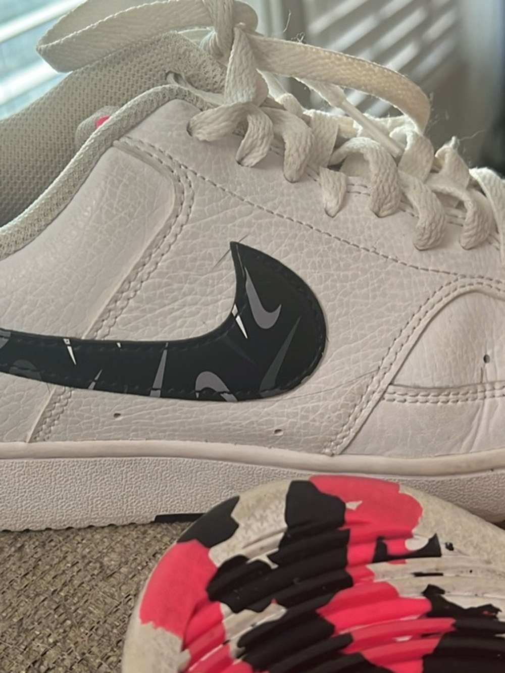 Nike White Leather Low-Top Sneakers with Black Patterned Swoosh and Pink Accent